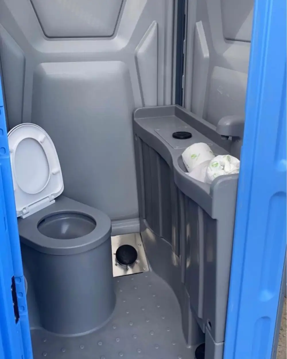 Inside a deluxe flushing portable toilet
