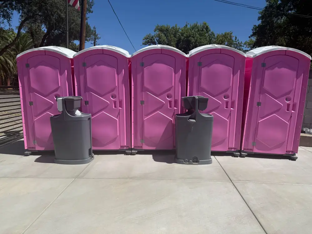Event porta potties lined up with two hand washing stations