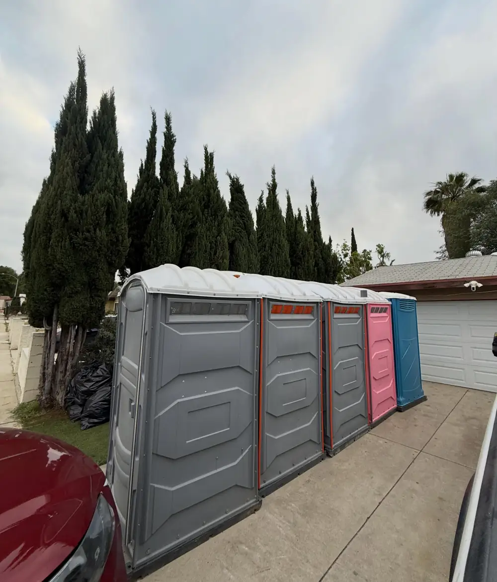 Porta potties lined up along a fence