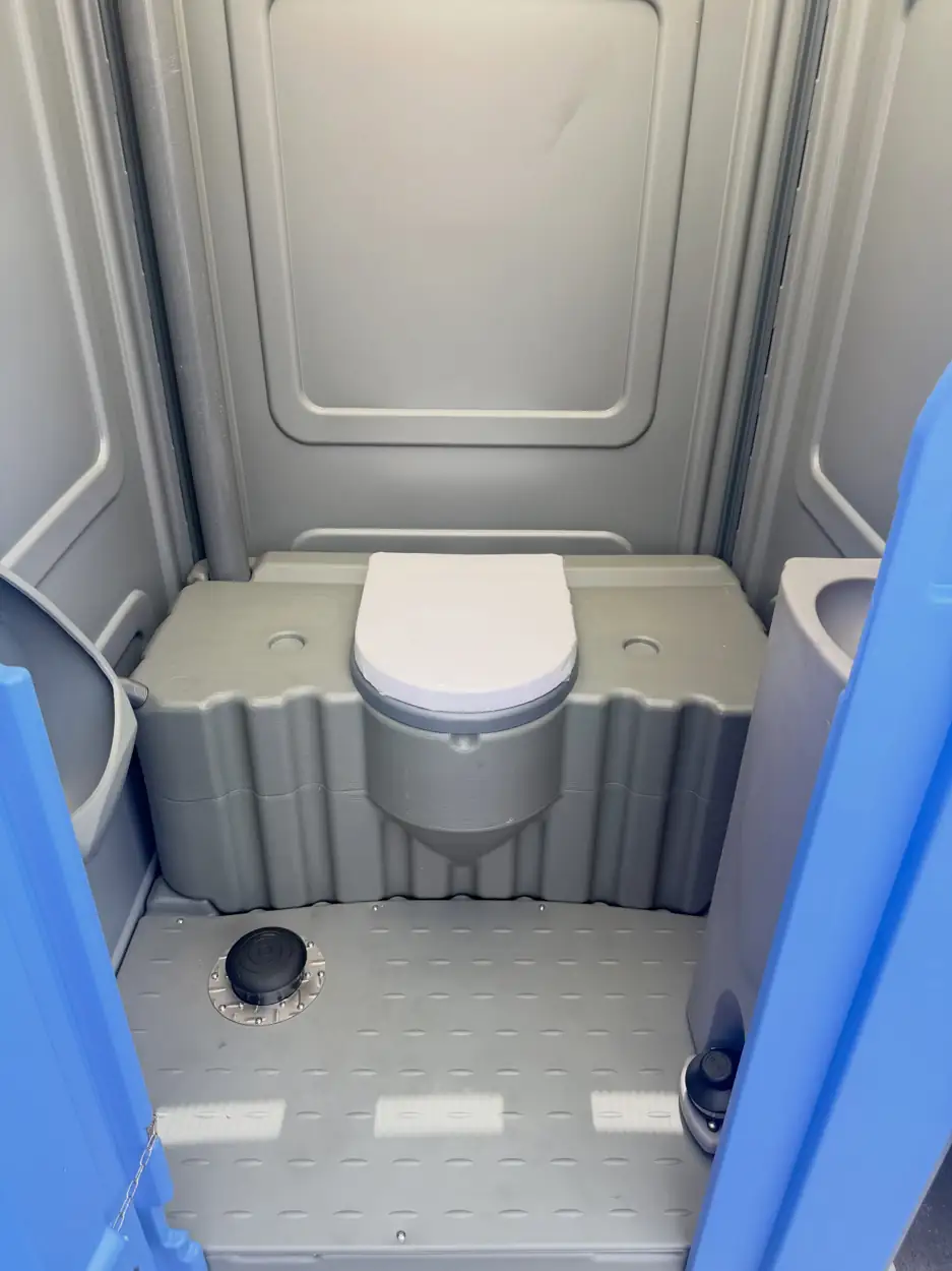 Clean interior floor of a serviced portable toilet