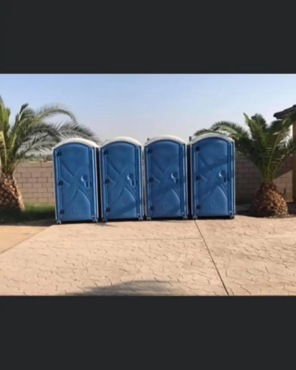 Row of standard porta potties set out for an event