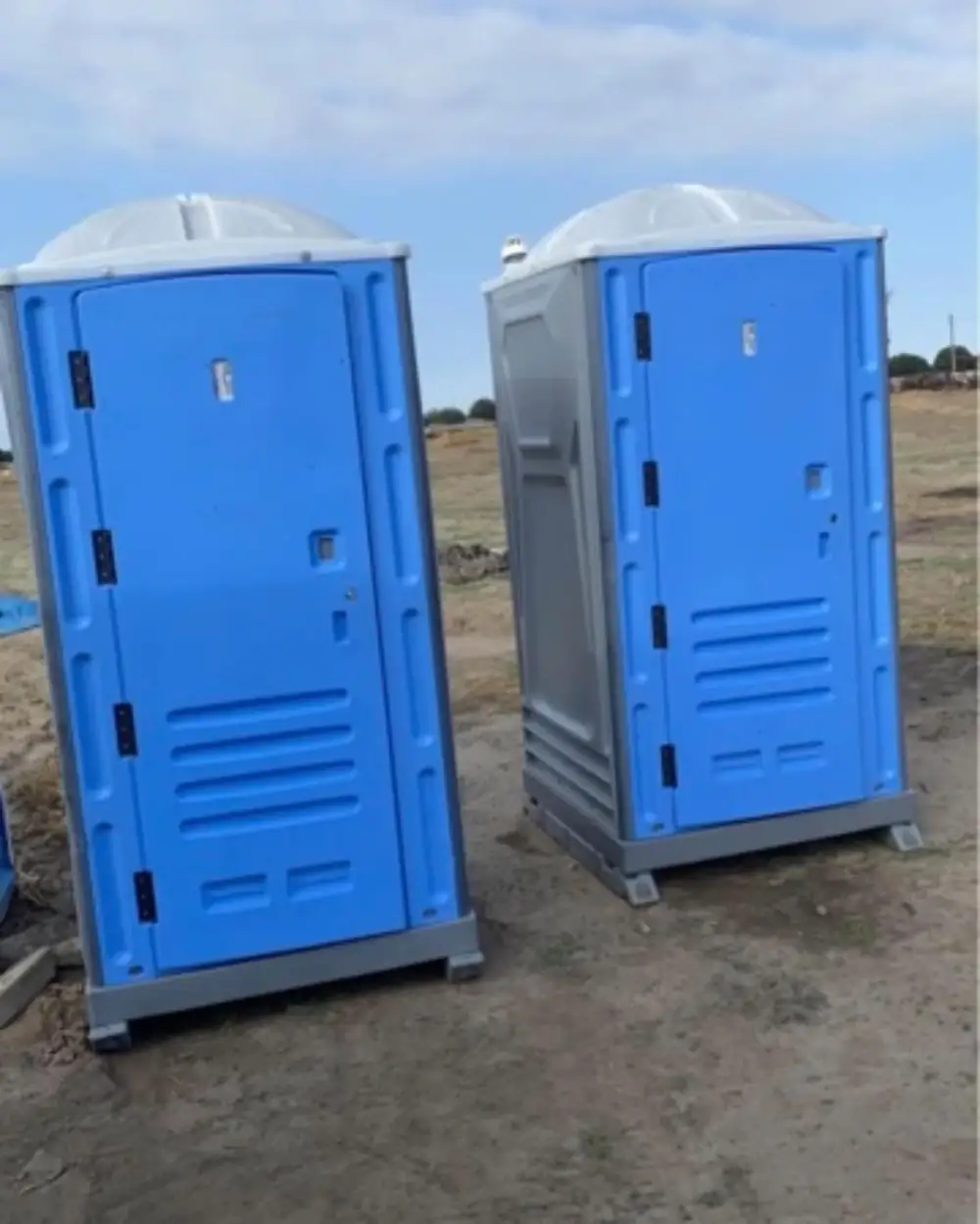 Standard porta potties set out in summer sun