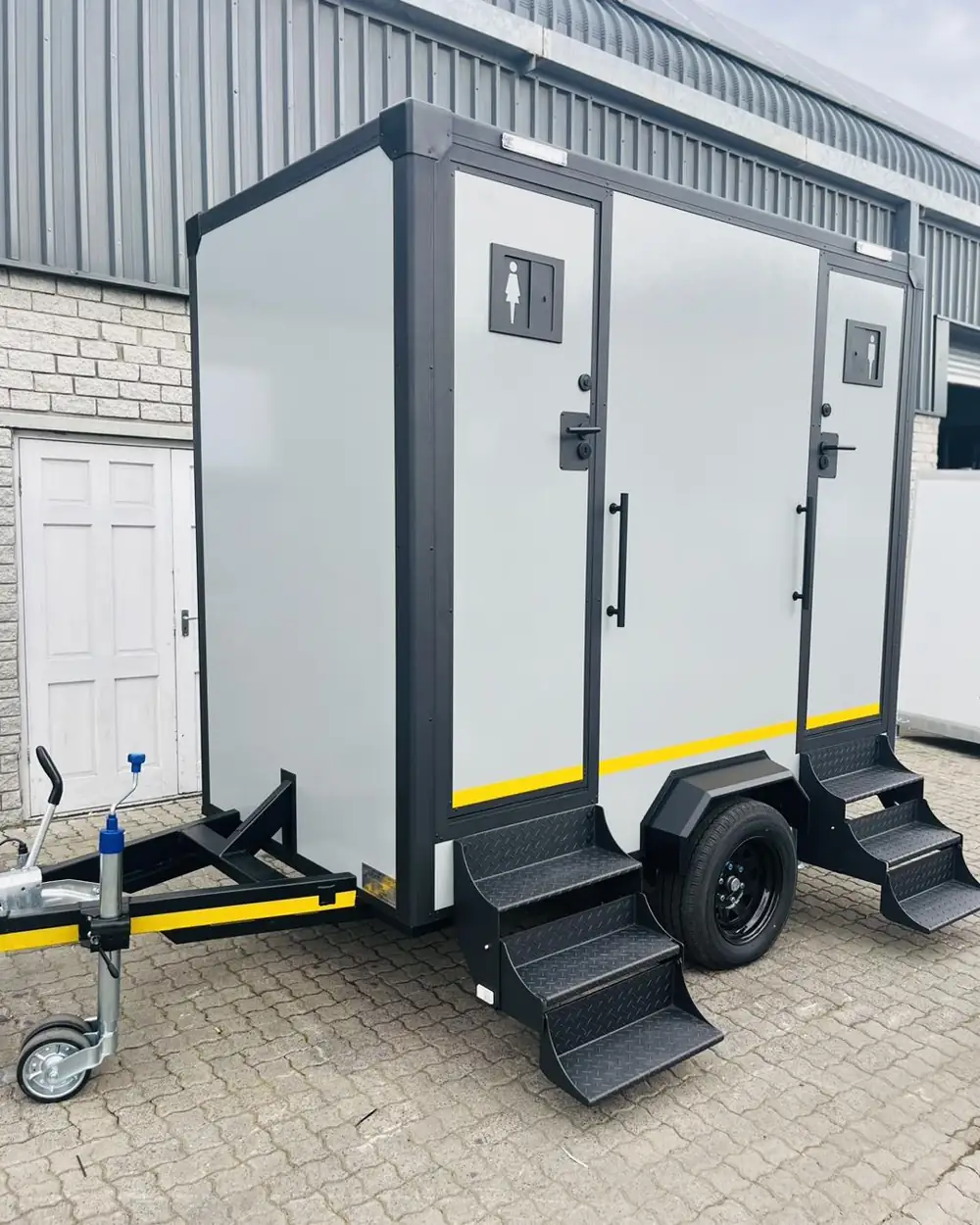 Two-stall restroom trailer exterior with steps